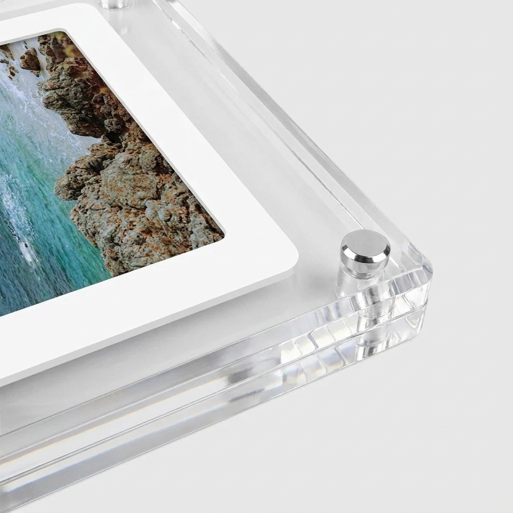 Clear acrylic picture frame with a white mat border holding a coastal landscape photo, shown on a light gray background.