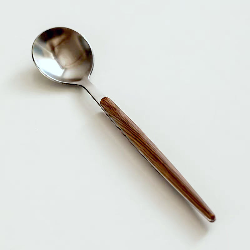 Spoon with wooden handle on a white background