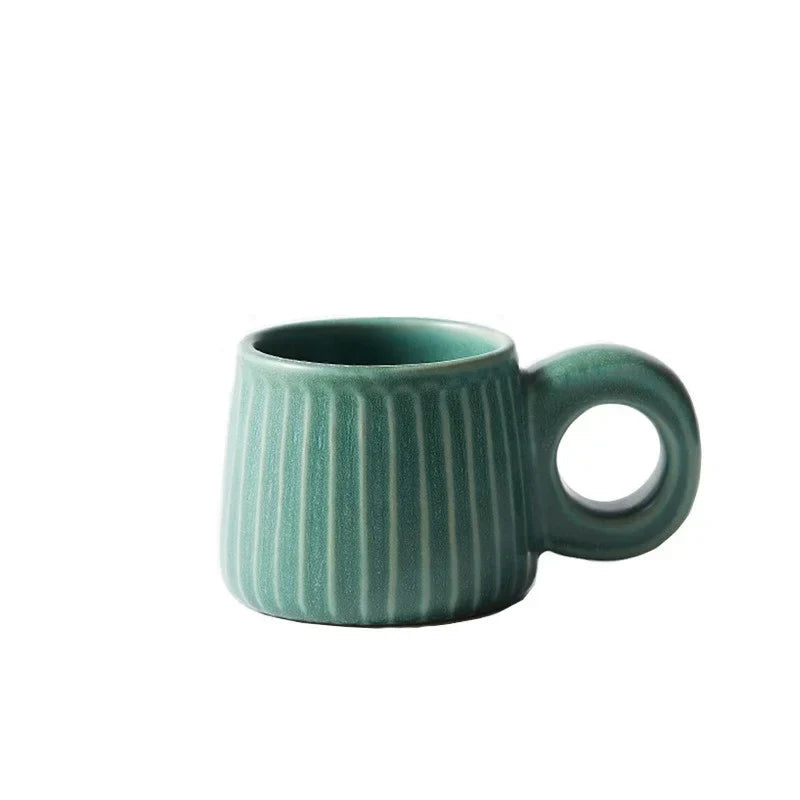 Green ceramic mug with ribbed texture on a white background