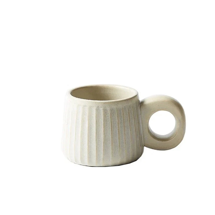 Beige ceramic mug with a textured design on a white background