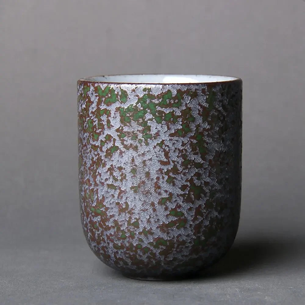 Ceramic cup with textured surface on a gray background