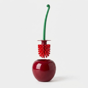 A glossy red cherry-shaped toilet brush holder with a green handle and red bristle brush, shown on a clean light gray background.