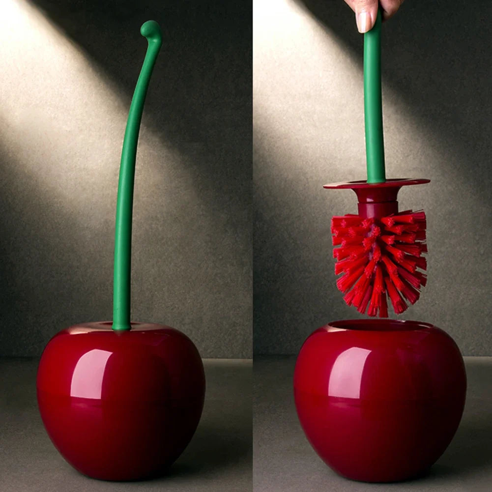 Red cherry-shaped brush with green handle on a gray background