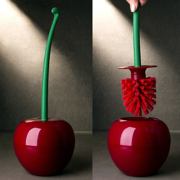 Red cherry-shaped brush with green handle on a gray background