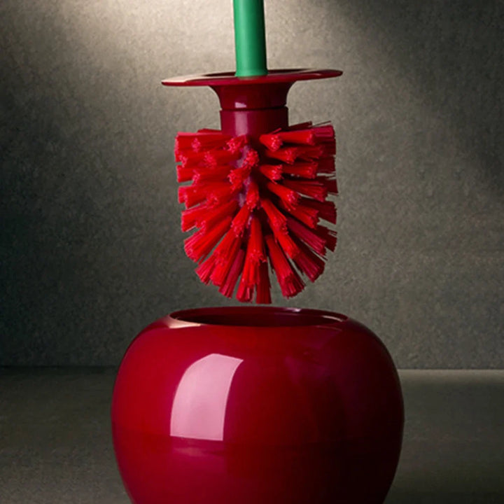 Red cleaning brush with bristle head on a red stand against a gray background
