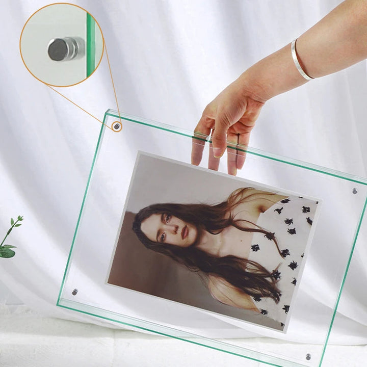 Clear photo frame with a hand holding it, displaying a photo of a woman on a white background.