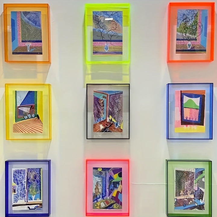 Colorful framed artworks on a white wall
