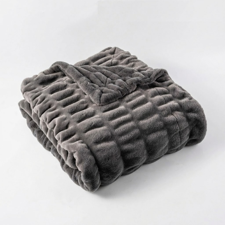 Folded gray blanket on a white background