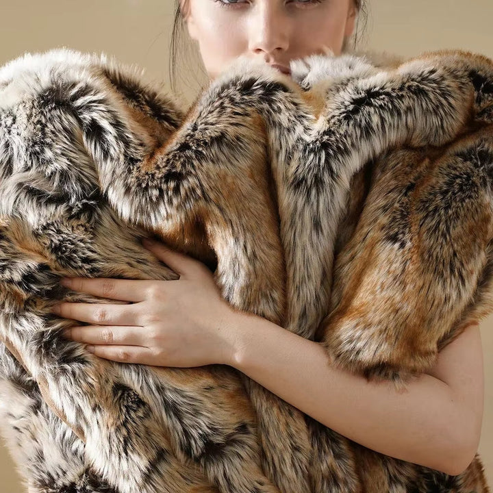 Person holding a large fur coat with a neutral background