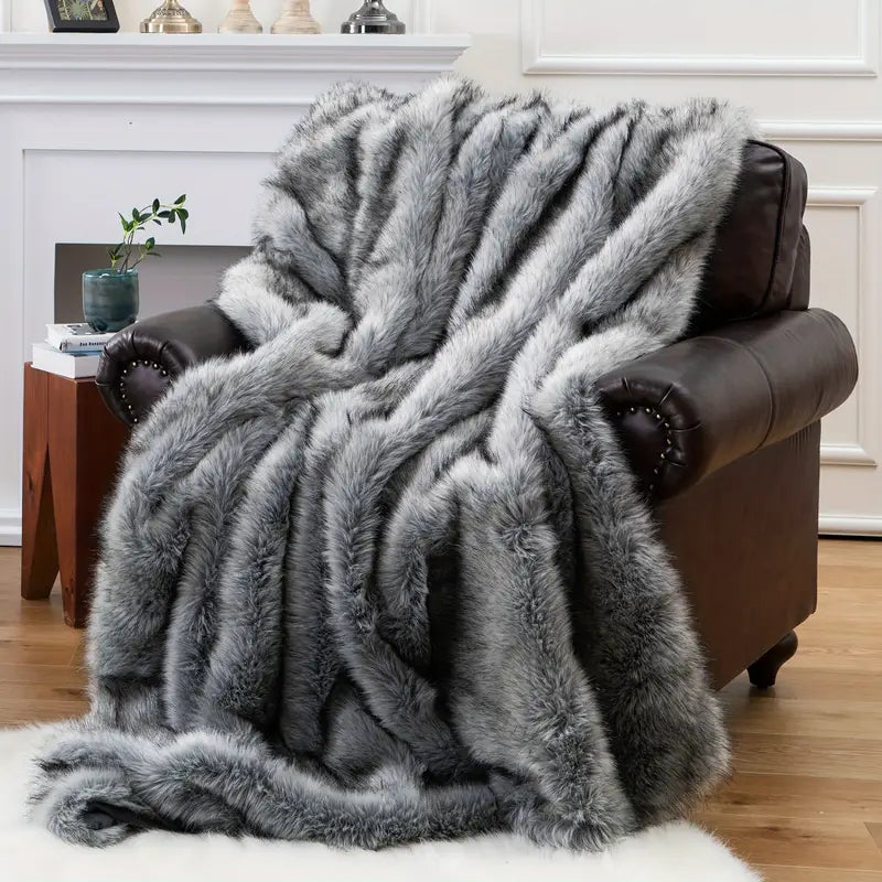 Gray faux fur blanket draped over a brown armchair in a living room setting.