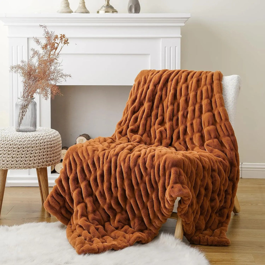 Brown textured blanket draped over a chair in a cozy living room setting.
