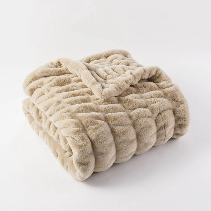 Beige textured blanket on a white background