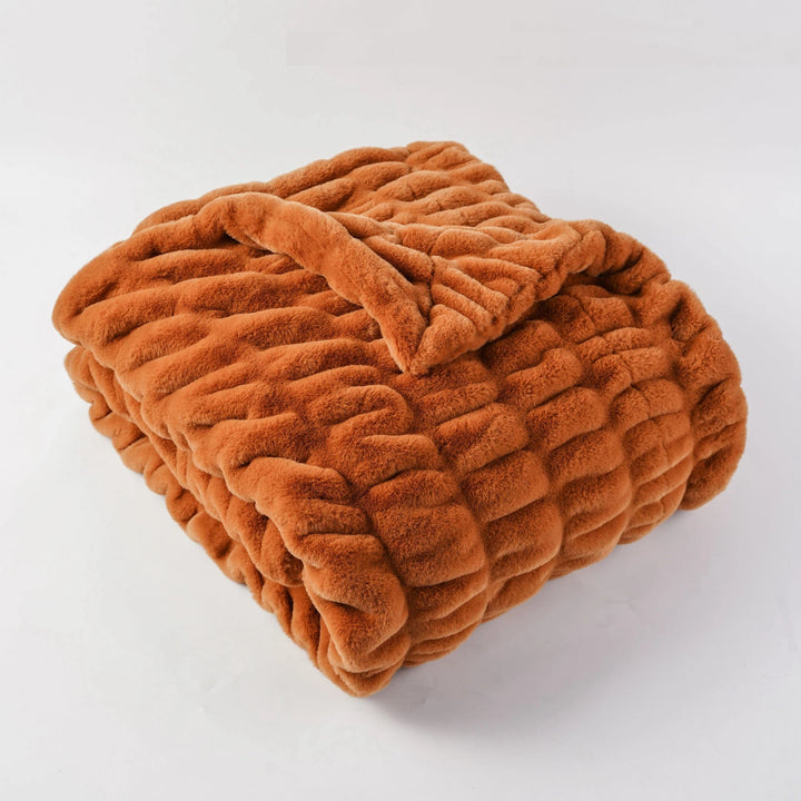Folded brown blanket on a white background