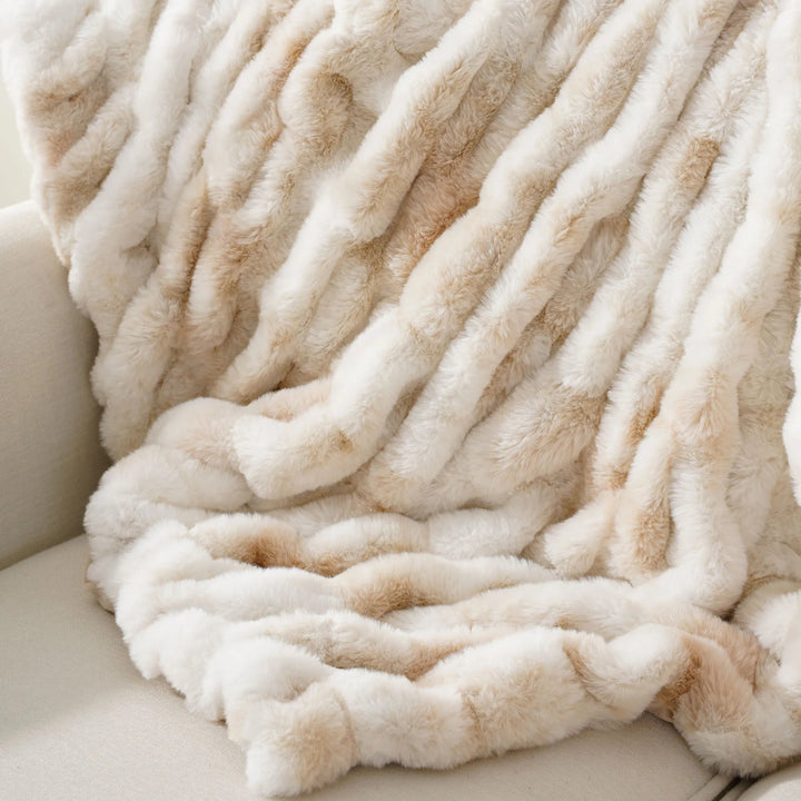 Cozy beige blanket draped over a surface