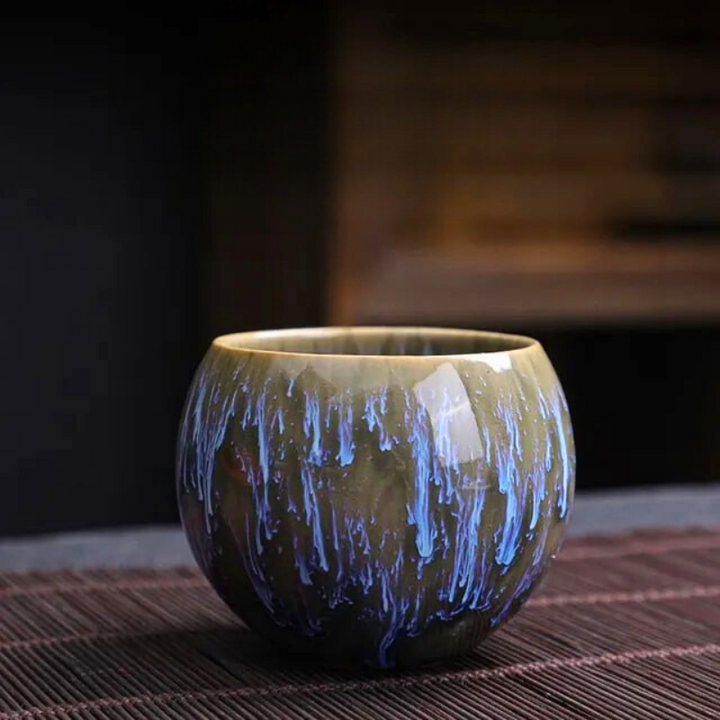 Ceramic cup with blue glaze on a dark background