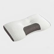 A contoured cervical pillow with a textured white fabric cover and a dark gray central support panel, shown on a light gray background.