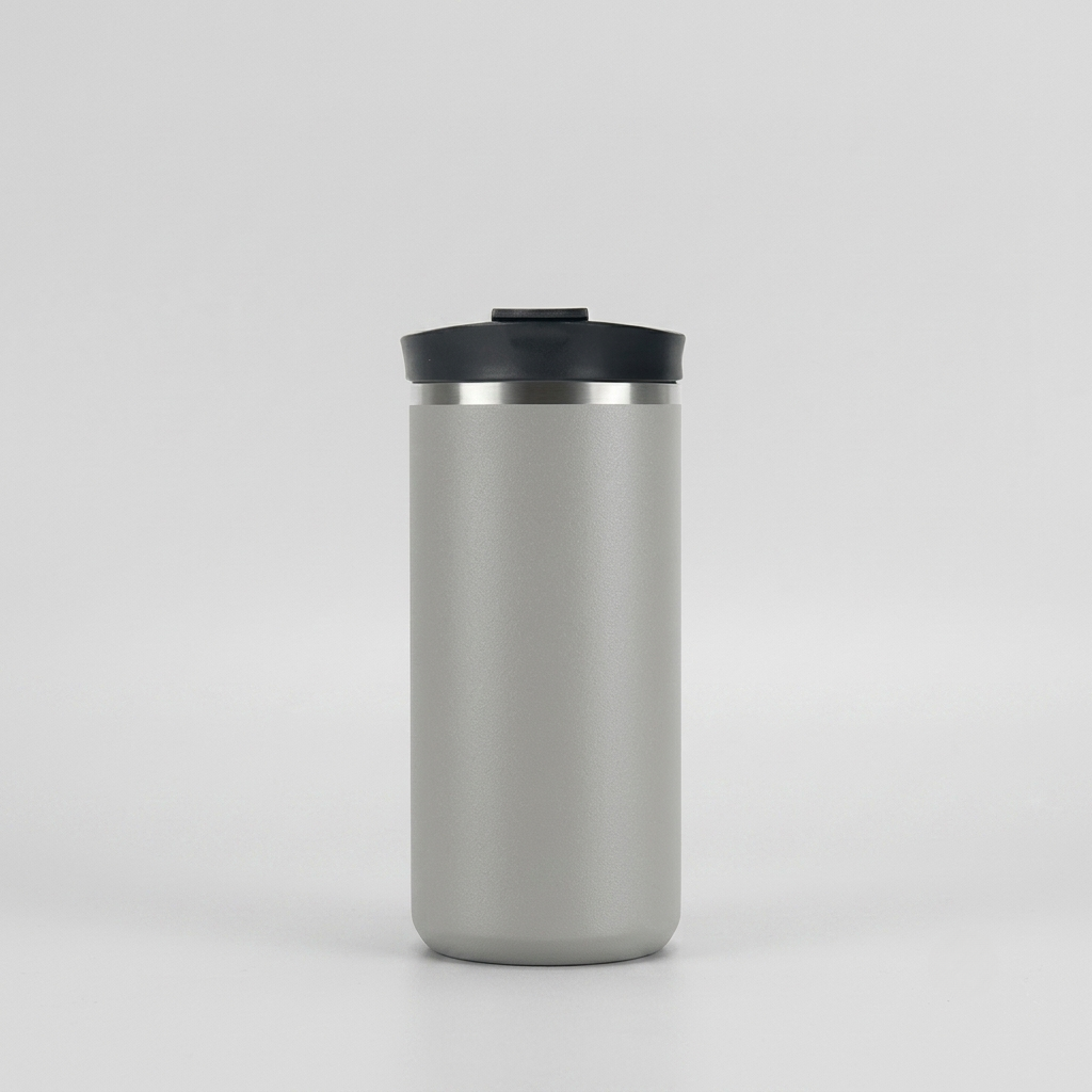 A matte gray insulated travel tumbler with a black lid and a thin silver metallic band, centered on a light gray background.