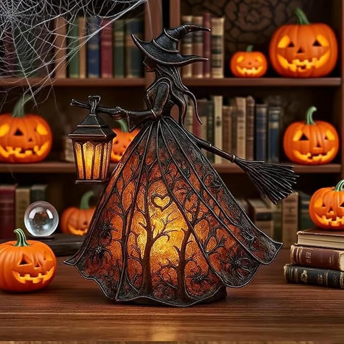 Halloween-themed decorative light with a witch design, surrounded by pumpkins and books.