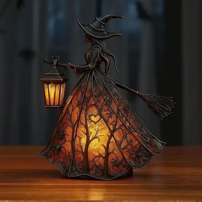 Decorative witch lamp with a lantern on a wooden surface