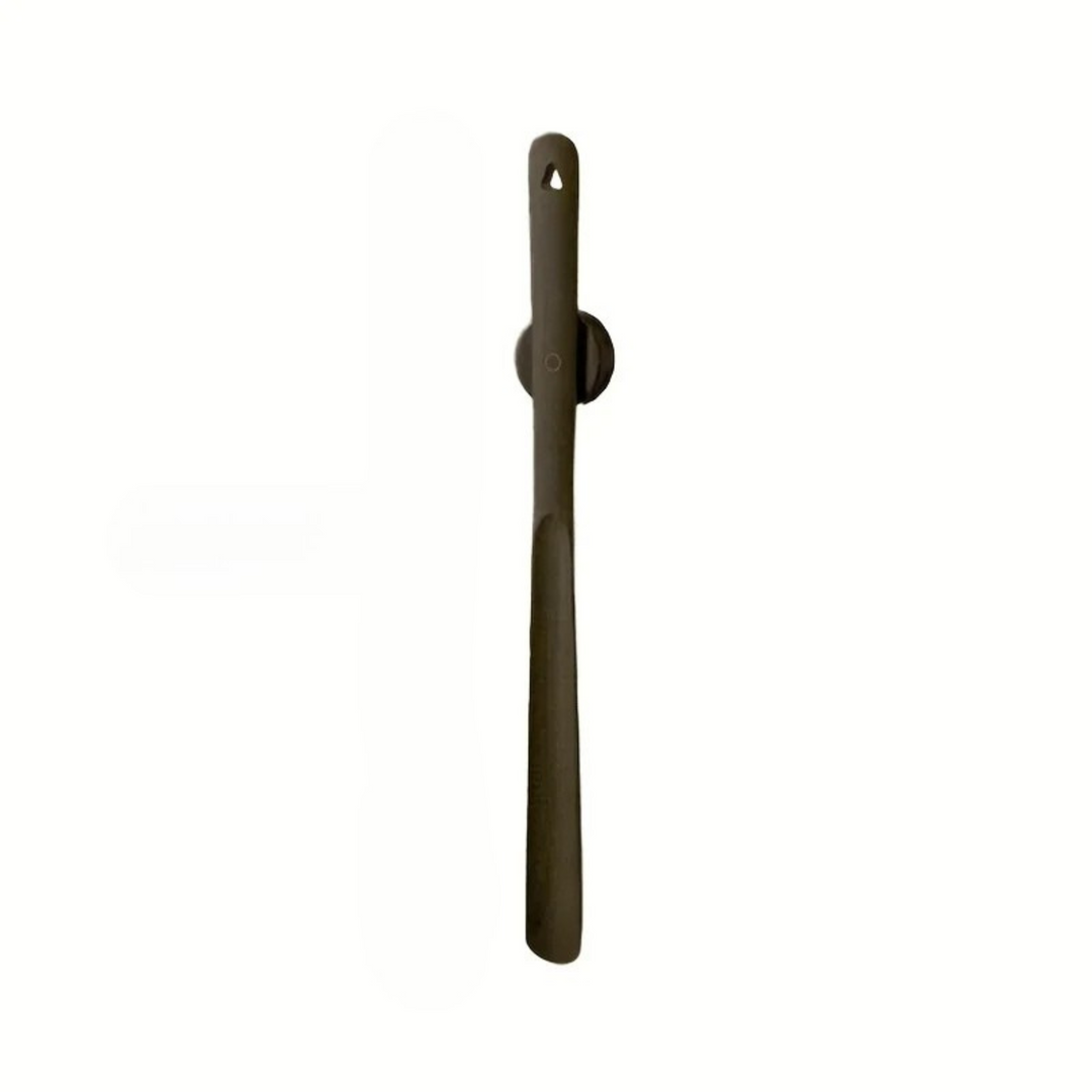 A single long, narrow dark brown tool or accessory with a rounded circular section near the top and a small hanging hole, shown vertically on a plain white background.