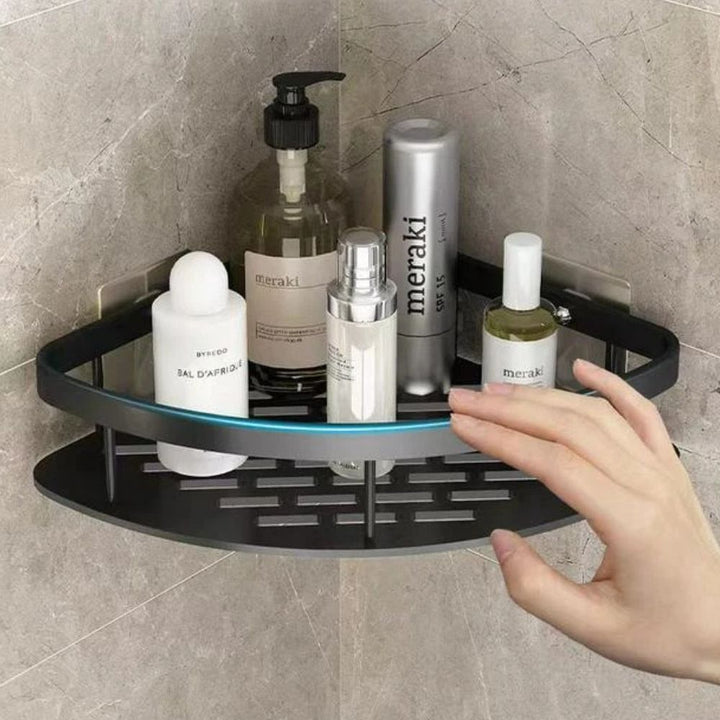 Corner shower caddy with various bottles on a tiled wall
