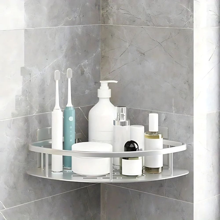 Corner shelf with bathroom products against a tiled wall