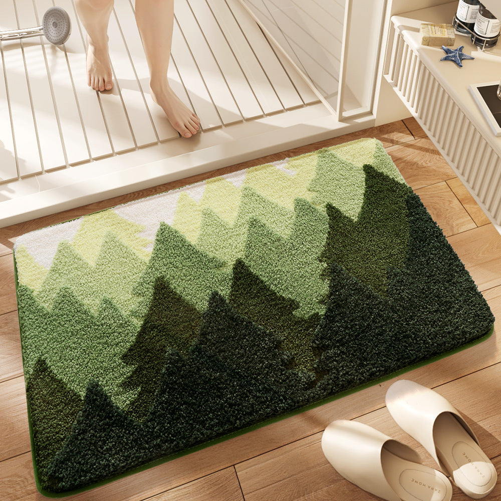 Green mountain-patterned rug on a wooden floor with a person stepping onto it.
