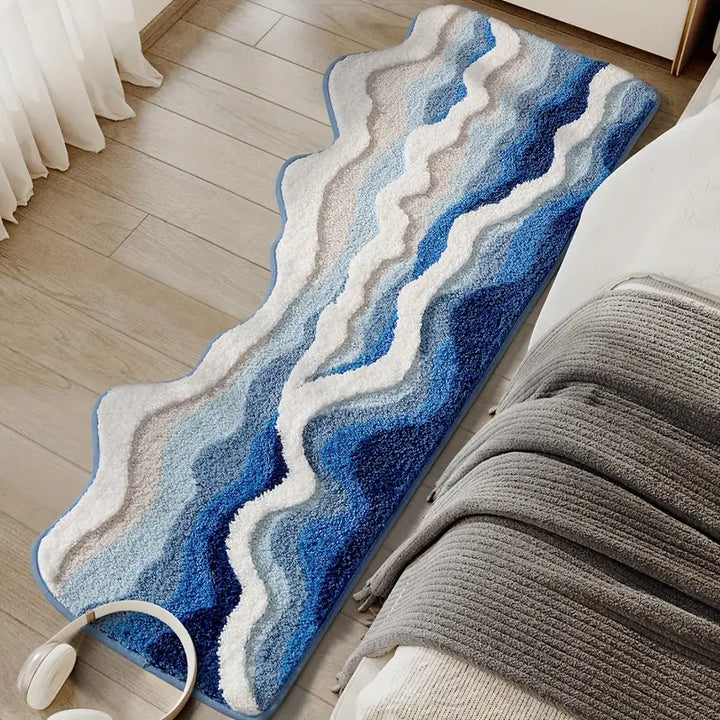 Blue and white wavy patterned rug on a wooden floor