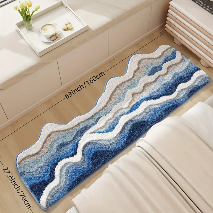 Blue and white wavy patterned rug on a wooden floor with a beige cabinet and tray in the background.