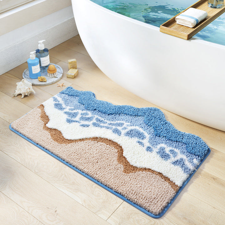 Bath mat with wave design on a bathroom floor next to a bathtub.