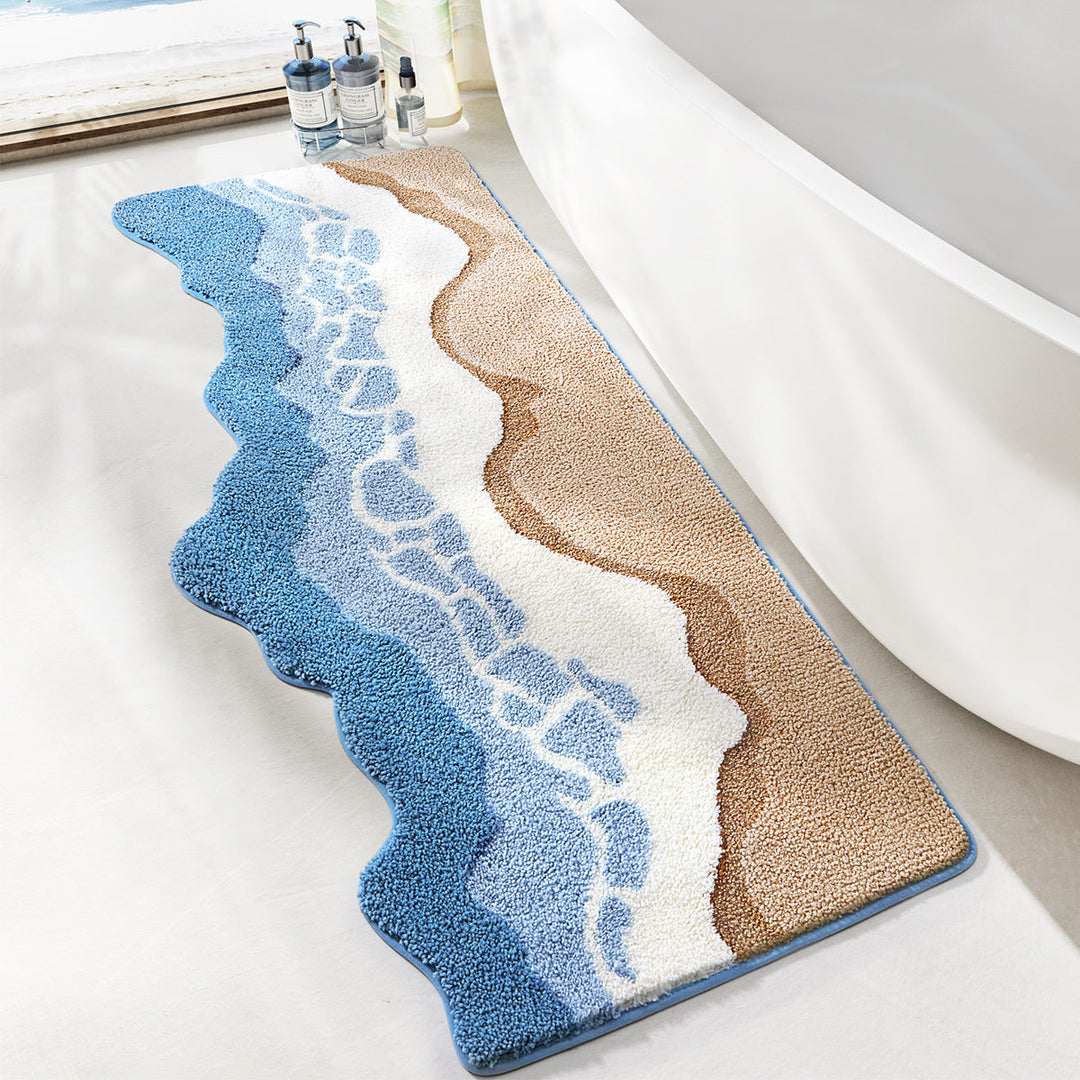Bath mat with wavy design in blue, beige, and white on a bathroom floor.