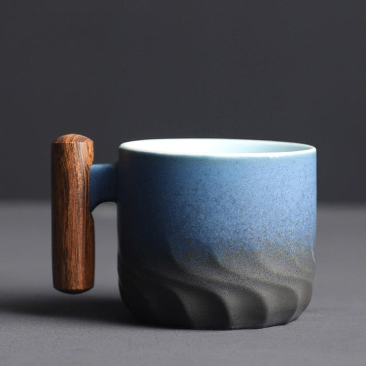 Blue ceramic mug with a wooden handle on a dark background