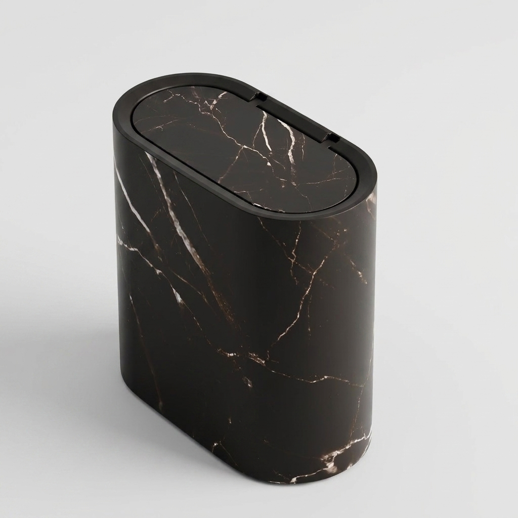 A modern oval-shaped trash can with a black marble pattern featuring white and subtle gold veining, set against a clean light gray background.