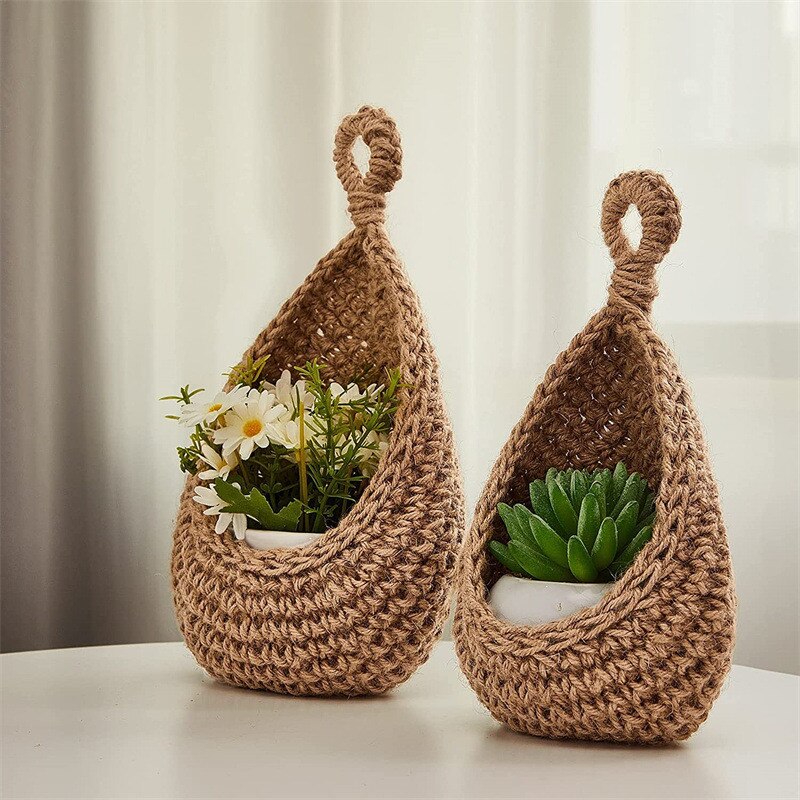 Two brown crochet plant holders with plants on a light background