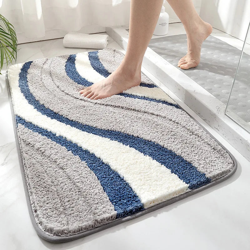 Bathroom mat with blue and white stripes on a bathroom floor.