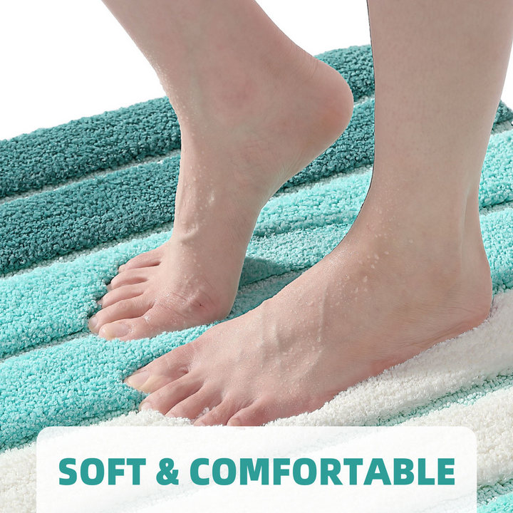 Teal and white striped bath mat with feet stepping onto it, labeled 'Soft & Comfortable'.