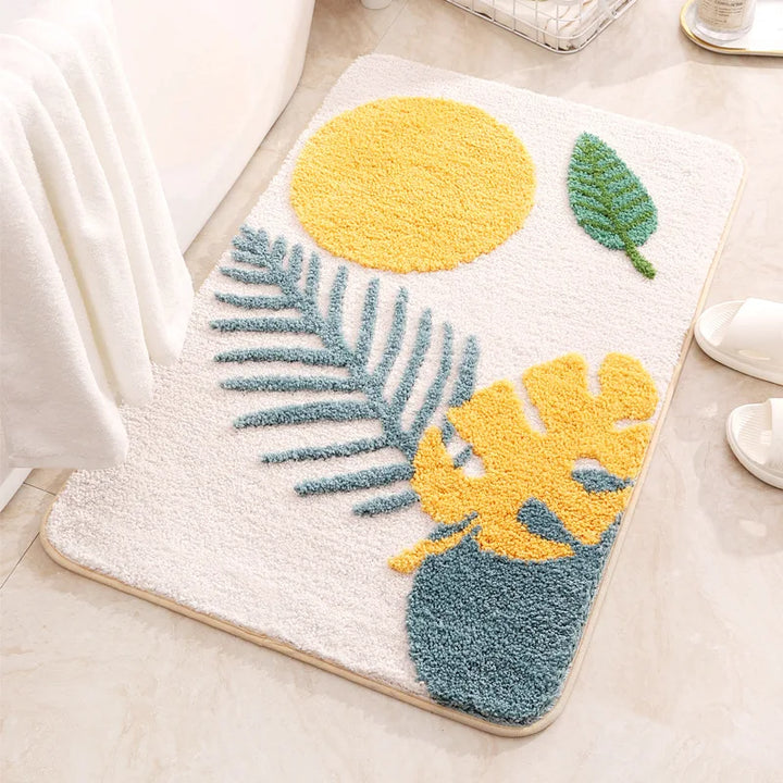 Decorative doormat with yellow and blue leaf patterns on a light background