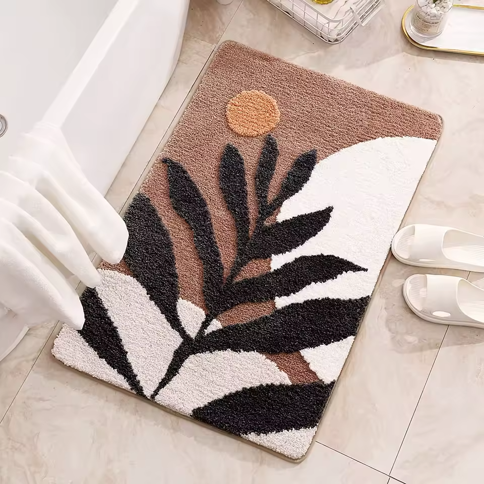 Decorative doormat with leaf design on a tiled floor