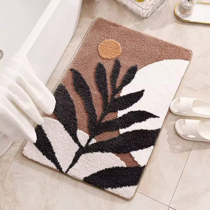 Decorative doormat with leaf design on a tiled floor