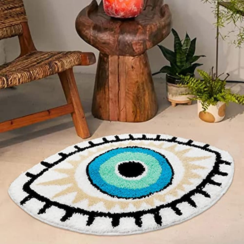 Round decorative rug with eye design in a room with wooden furniture and plants.