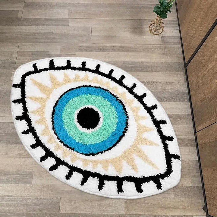 Eye-shaped rug with a blue center and black, white, and beige accents on a wooden floor.