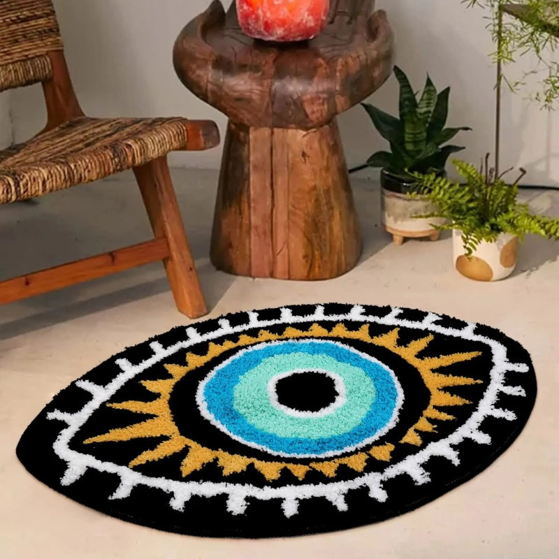 Round decorative rug with a colorful eye design in a room with a wooden chair, table, and plants.