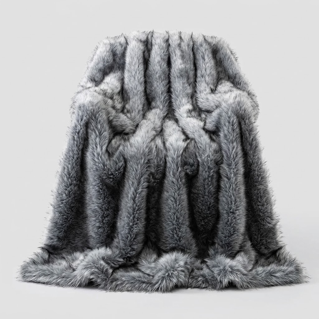 A plush faux fur throw blanket in a mottled gray and white colorway, draped over a chair against a neutral light gray background.