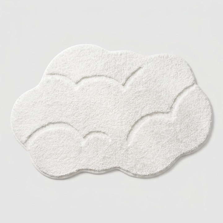 A fluffy white cloud-shaped bath mat with embossed wavy lines, shown on a light gray background.