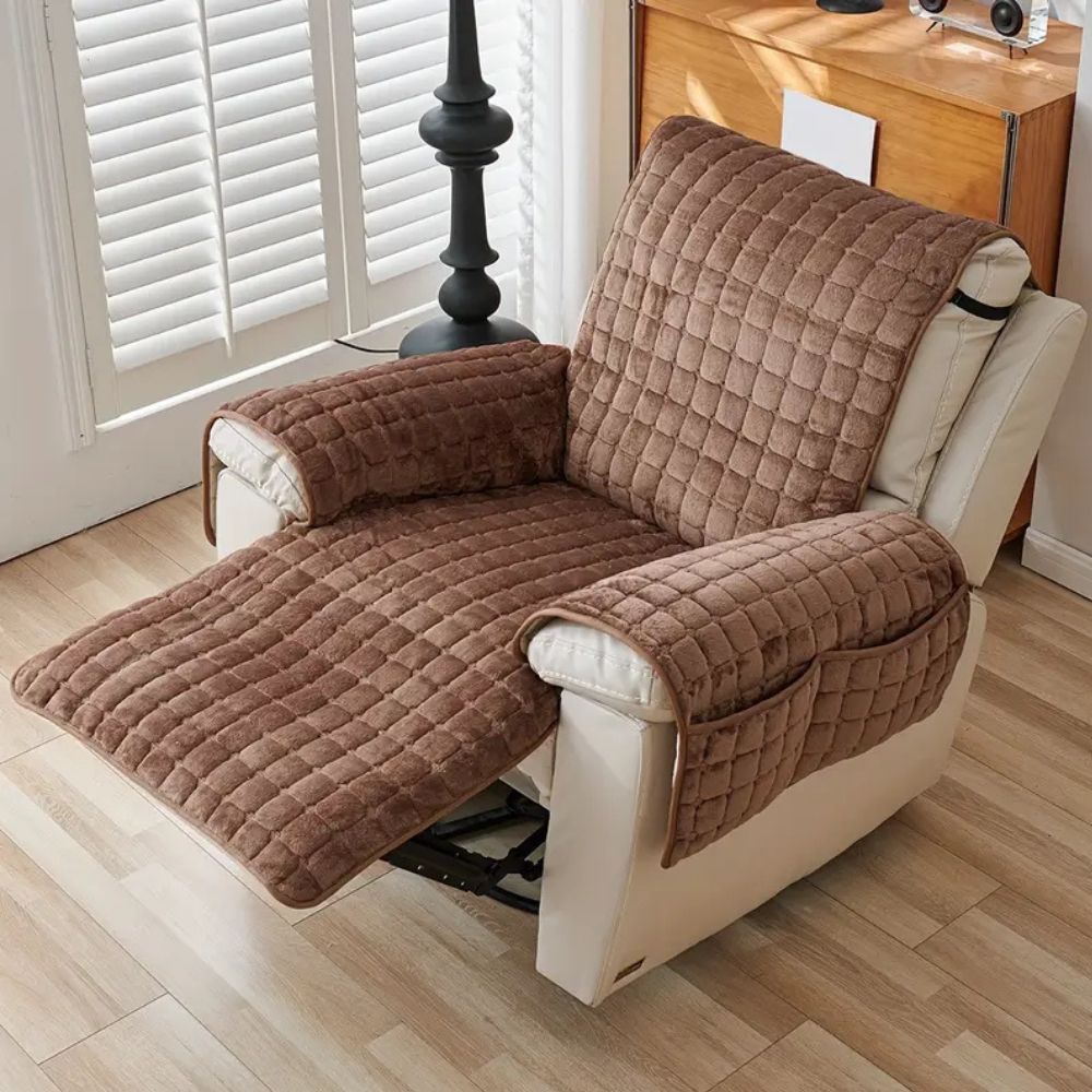 Brown quilted chair cover on a recliner chair in a room with wooden flooring and a window.