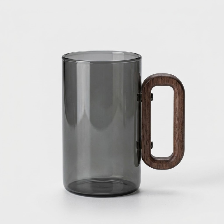 A translucent smoky gray glass mug with a thick, rounded dark brown wooden handle, shown on a clean light gray background.