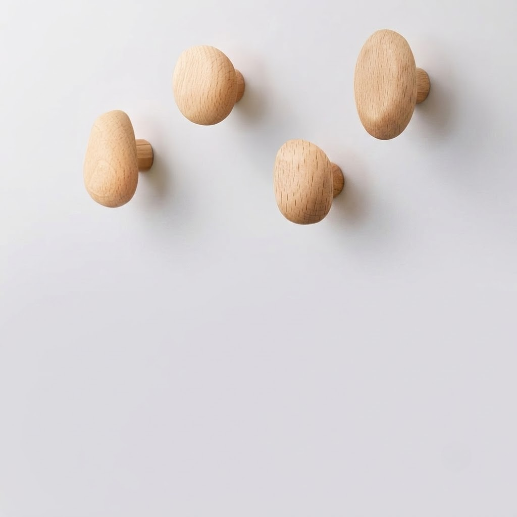 Four light natural wood knobs with rounded mushroom-like shapes, shown against a clean white background.