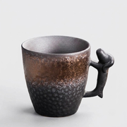A single matte dark brown wall hook with a hanging loop at the top, shown against a solid light gray background.