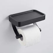 A matte black wall-mounted toilet paper holder with an integrated rectangular tray above a roll of toilet paper, shown against a plain light gray wall.
