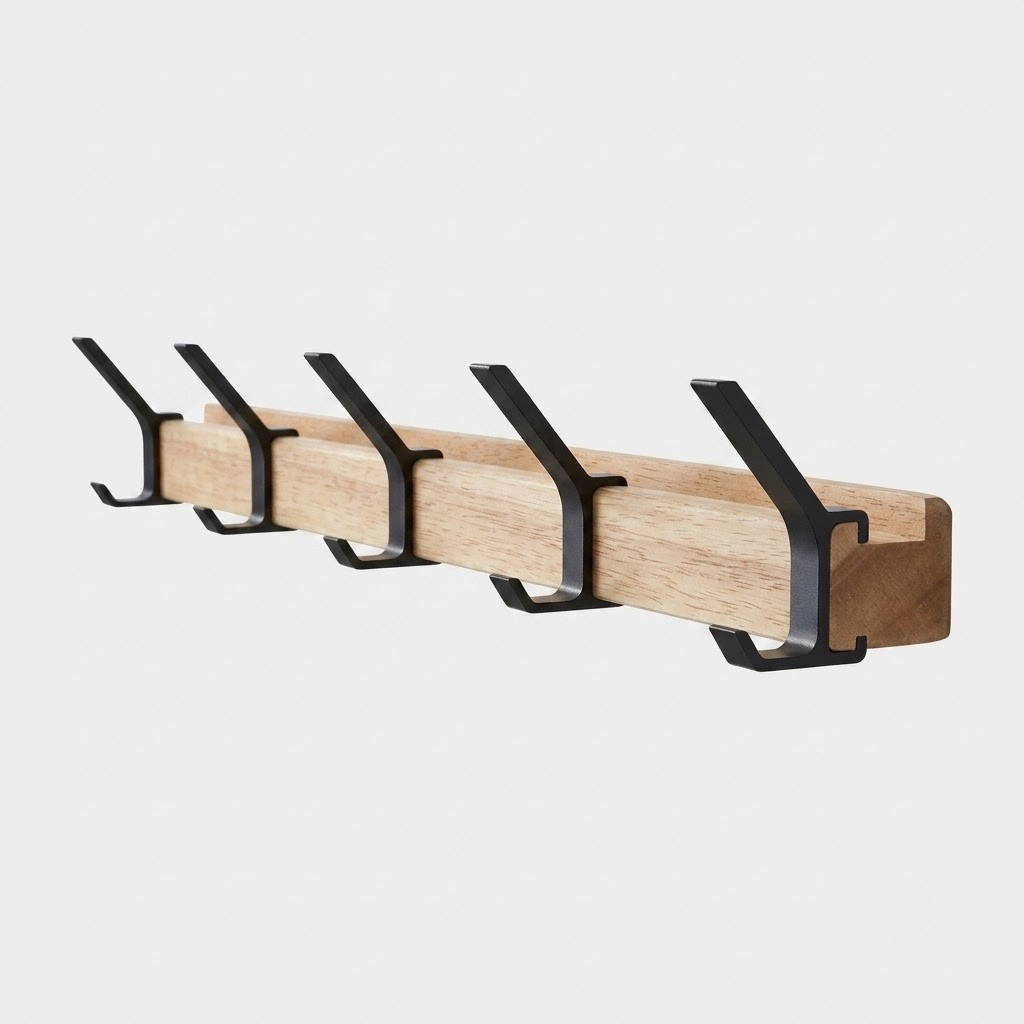 A wall-mounted wooden coat rack with five black metal hooks, shown against a light gray background.